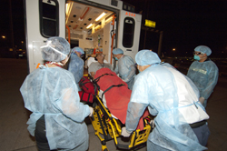 The sick passenger is transferred to hospital.