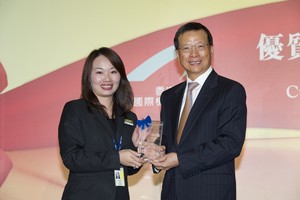 Individual award winner Angel Choi repairs a girl's rabbit doll, resulting in a smile on her face and warm memories of her visit in Hong Kong.